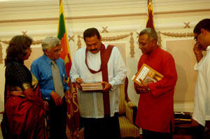 Prasident Mahinda Rajapaksa receiving the first two book of Prof. Anuradha Seneviratna